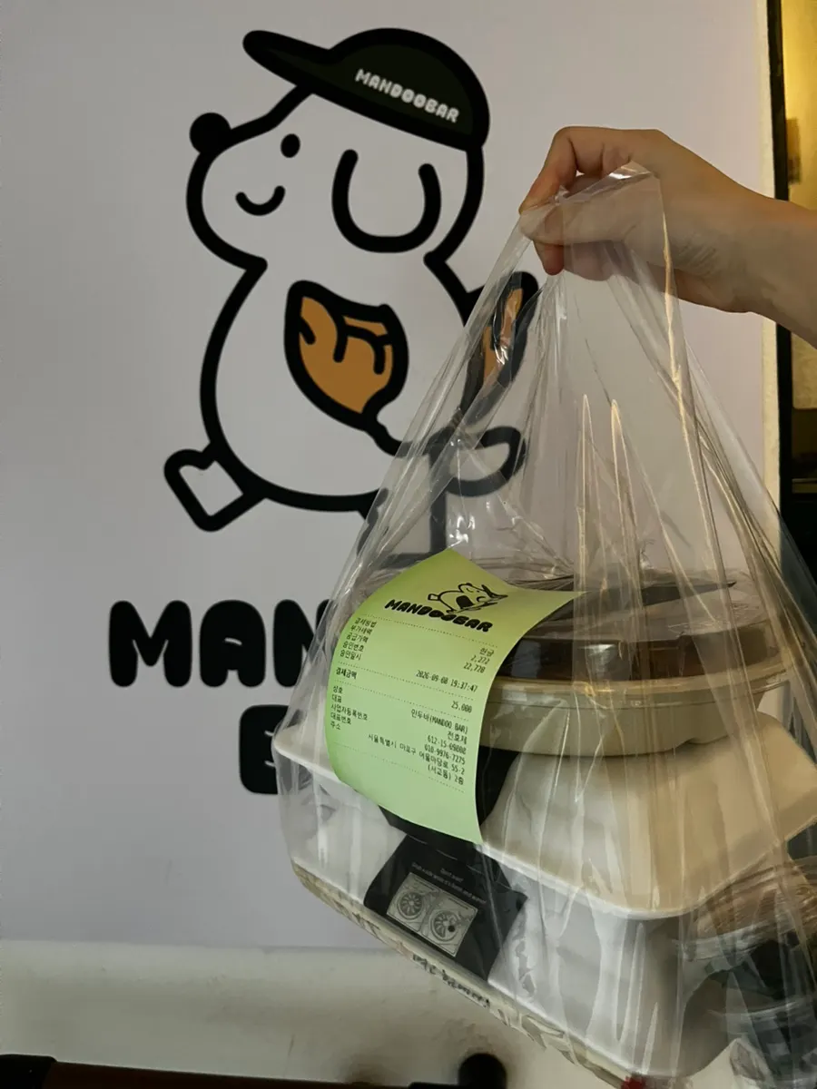 Neatly packed MANDOO BAR takeout bag