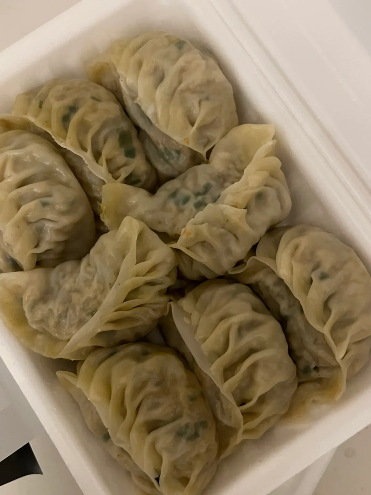 Steamed dumplings served half meat, half kimchi