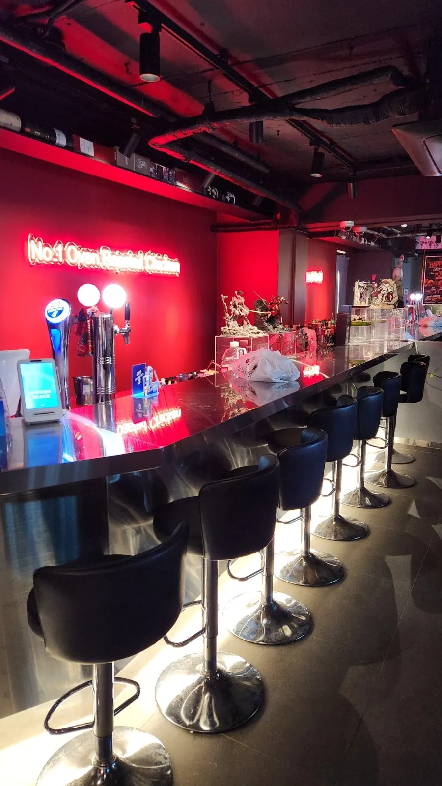 Storefront entrance with black arched facade and red lighting
