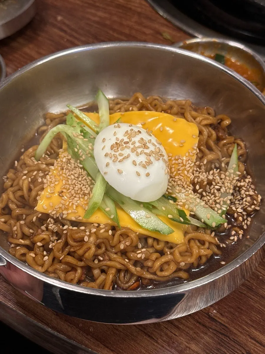 Jjagyechi topped with egg and cheese