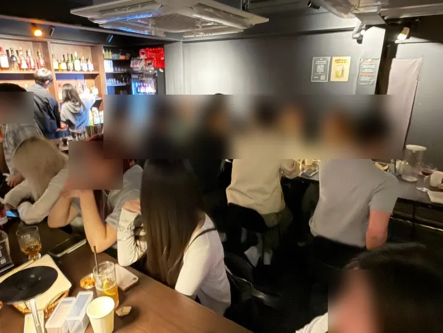 Bar seating full of guests