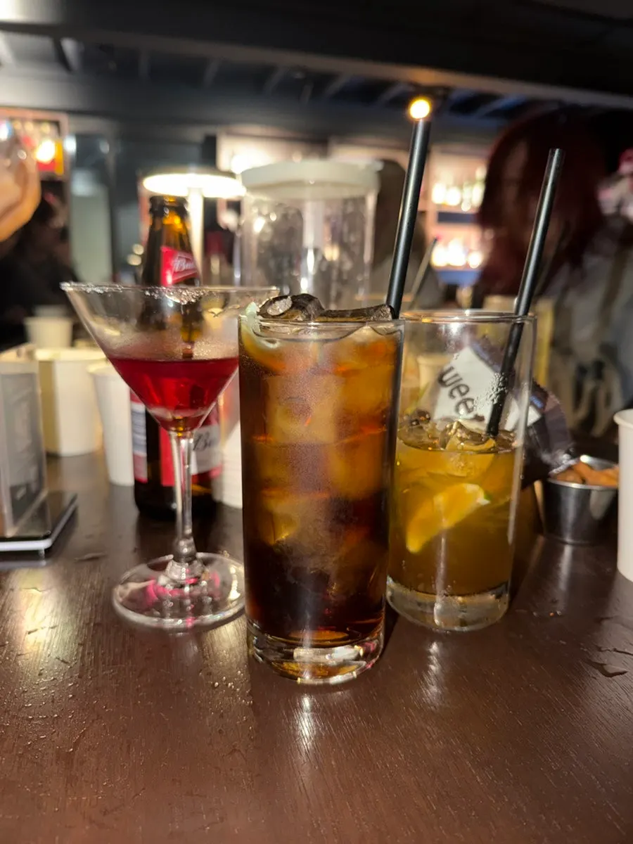 Conversation continuing at a table at the solo drinking bar