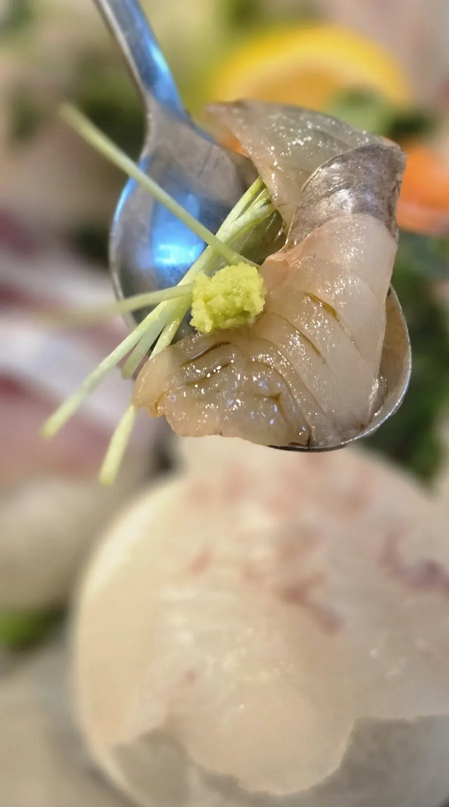 Picking up a piece of sashimi with ssamjang dipping sauce