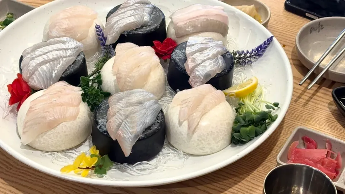 A thickly sliced piece of raw fish sashimi
