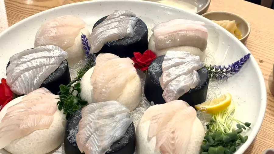 A drinking table set with sashimi and soju