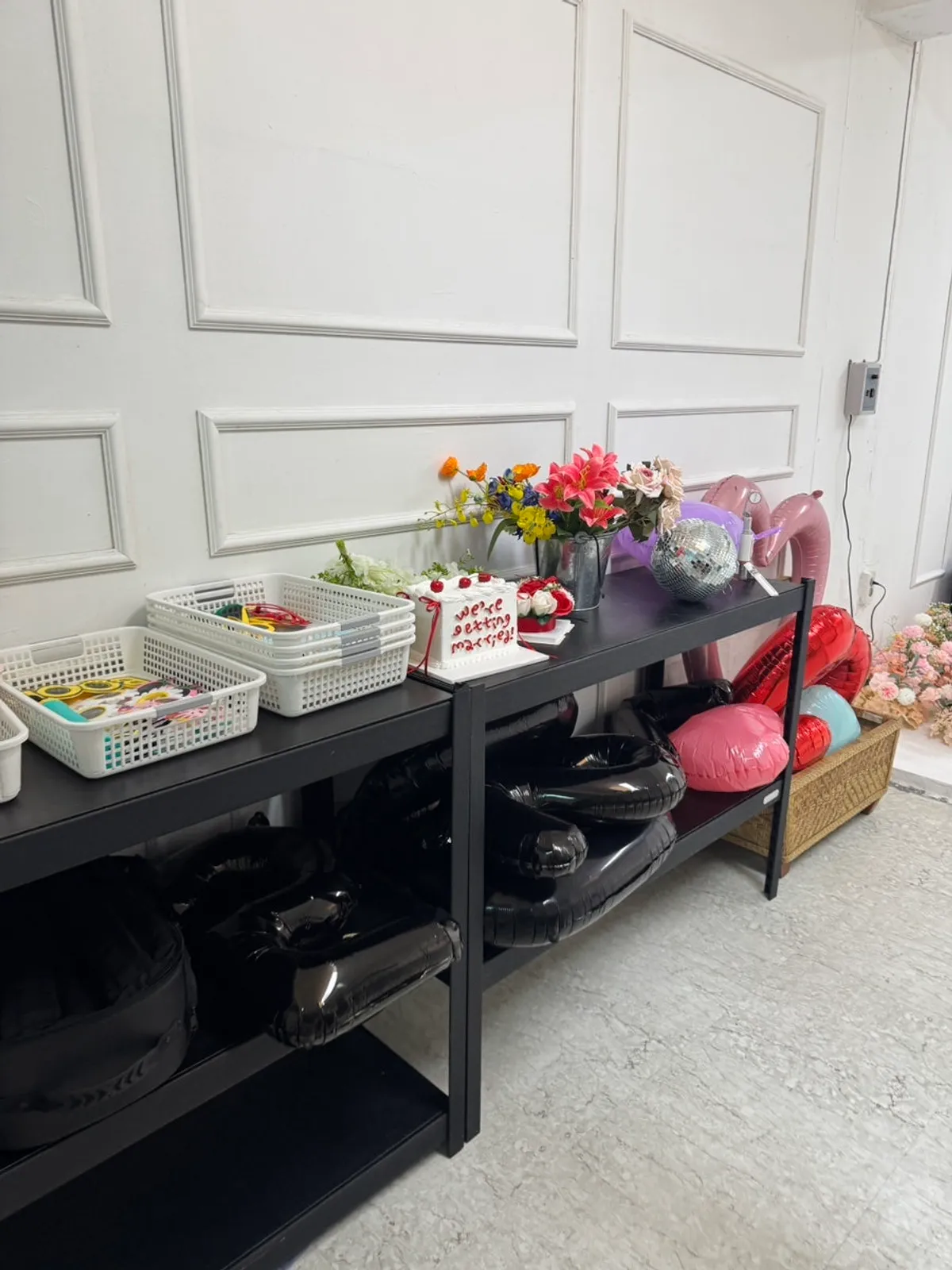 Flowers, balloons, and other anniversary shoot props on display