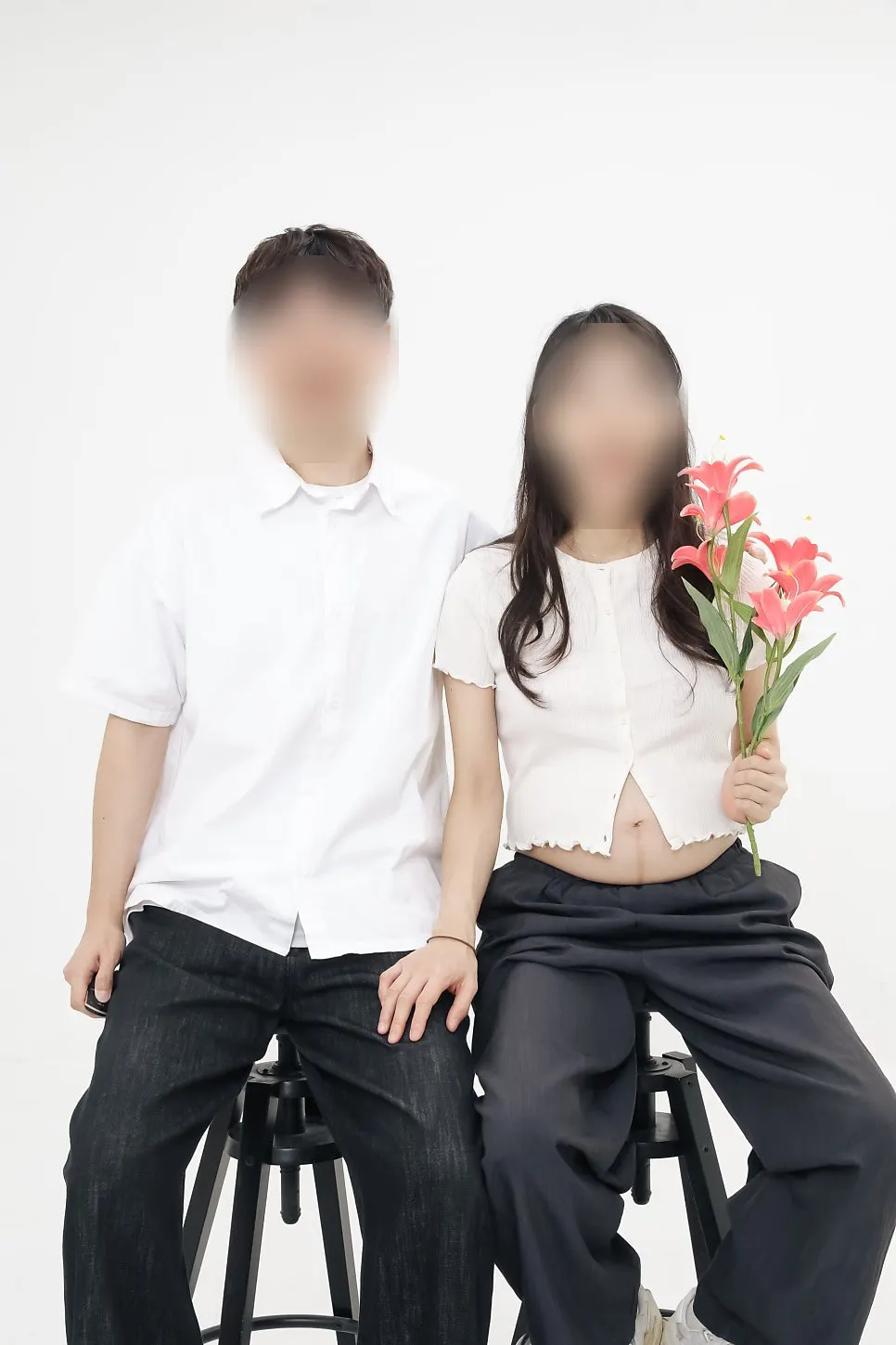 Maternity photo taken holding the studio's artificial flowers