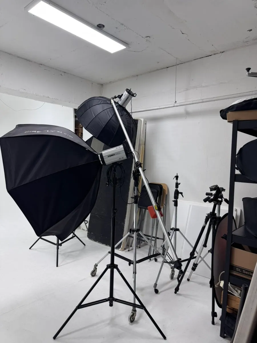 Corner of the studio with suits and a cake prop ready