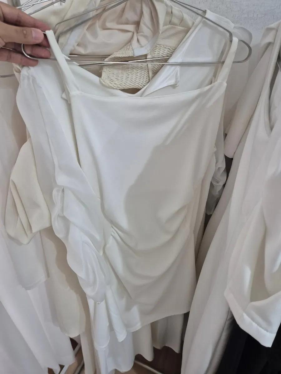 Costume rental corner with white dresses hanging