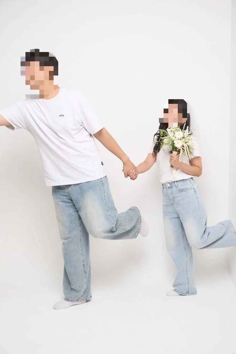 Couple posing with props in the studio
