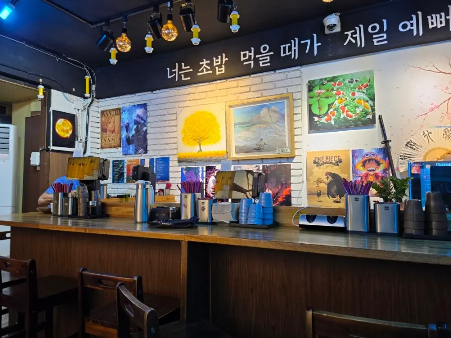 Interior seating and wall signs at Yu Iksang Sushi