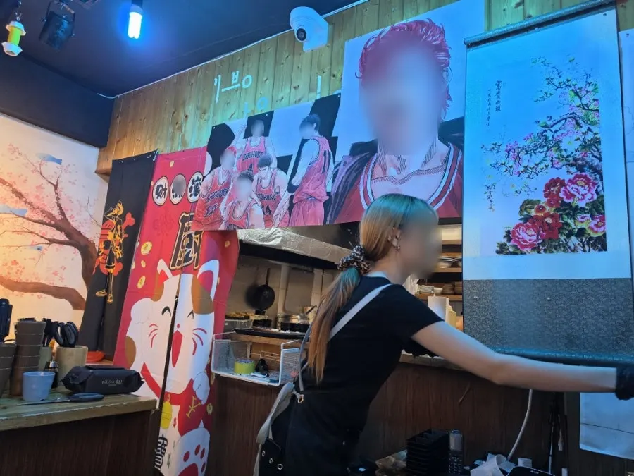 Interior of Yu Iksang Sushi decorated with anime posters