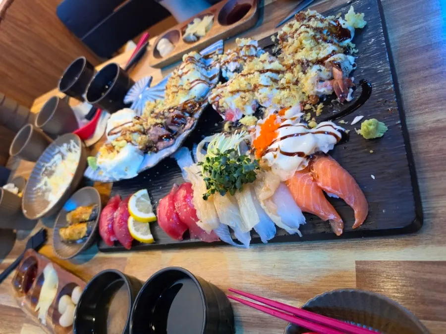 Platter of sushi with long draping fish tails