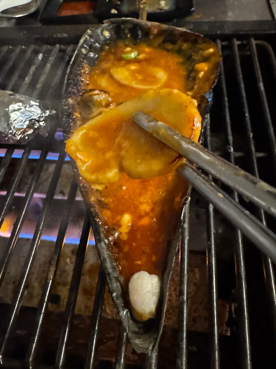 Grilled clams dipped in sauce