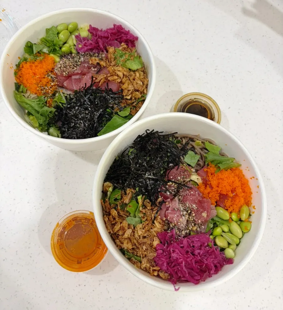 Two tuna poke bowls packed to go