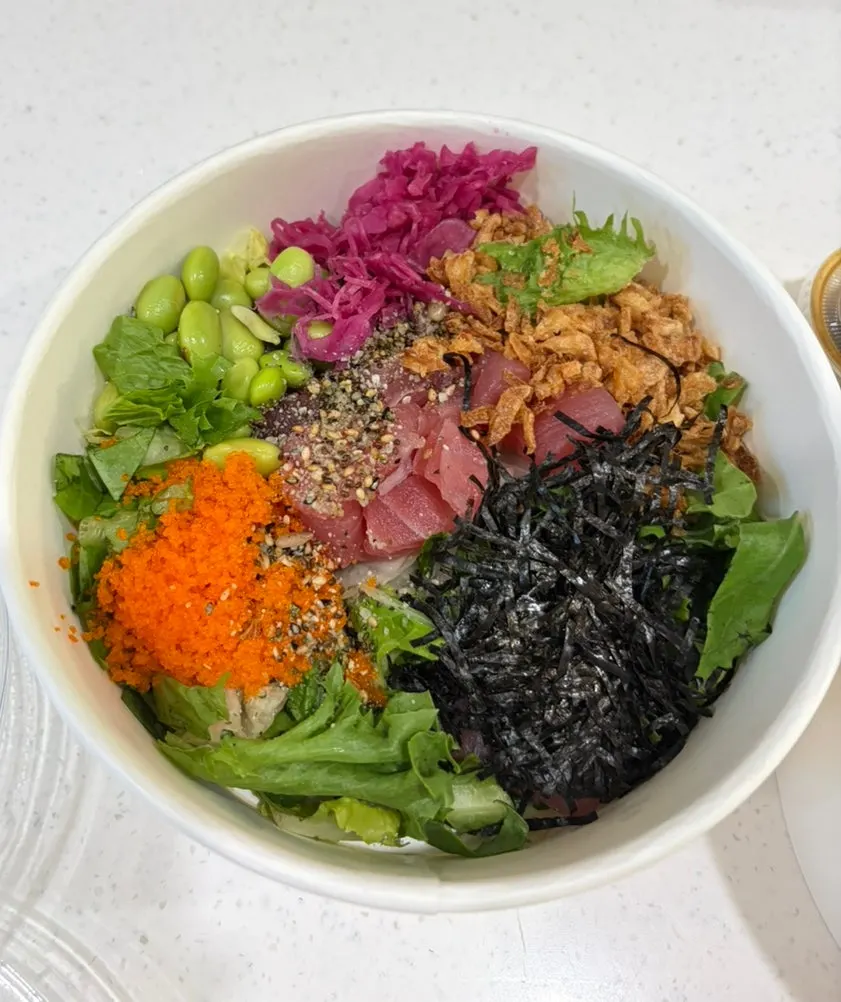 Opened takeout container of tuna poke