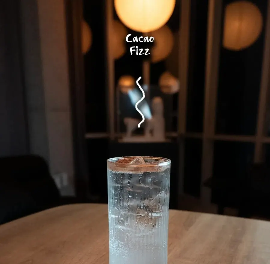 Drinks and small items placed on a seat at Tipsy Couch
