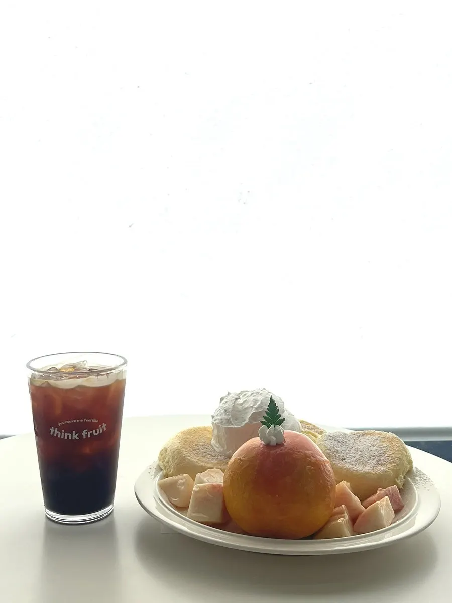 Cross-section of the peach soufflé topped with white and yellow peach