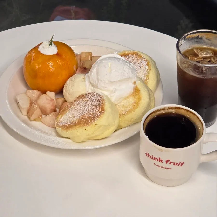 Peach soufflé topped with a whole peach, whipped cream, and Häagen-Dazs vanilla