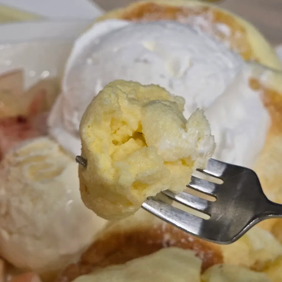 Pressing a fork into the thick soufflé pancake