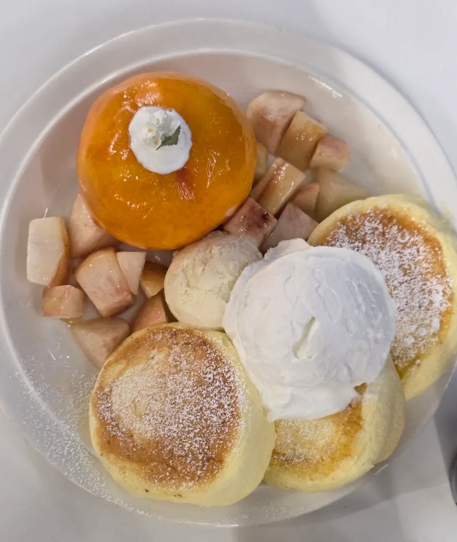 A vertical shot of the full peach soufflé setup at Think Fruit