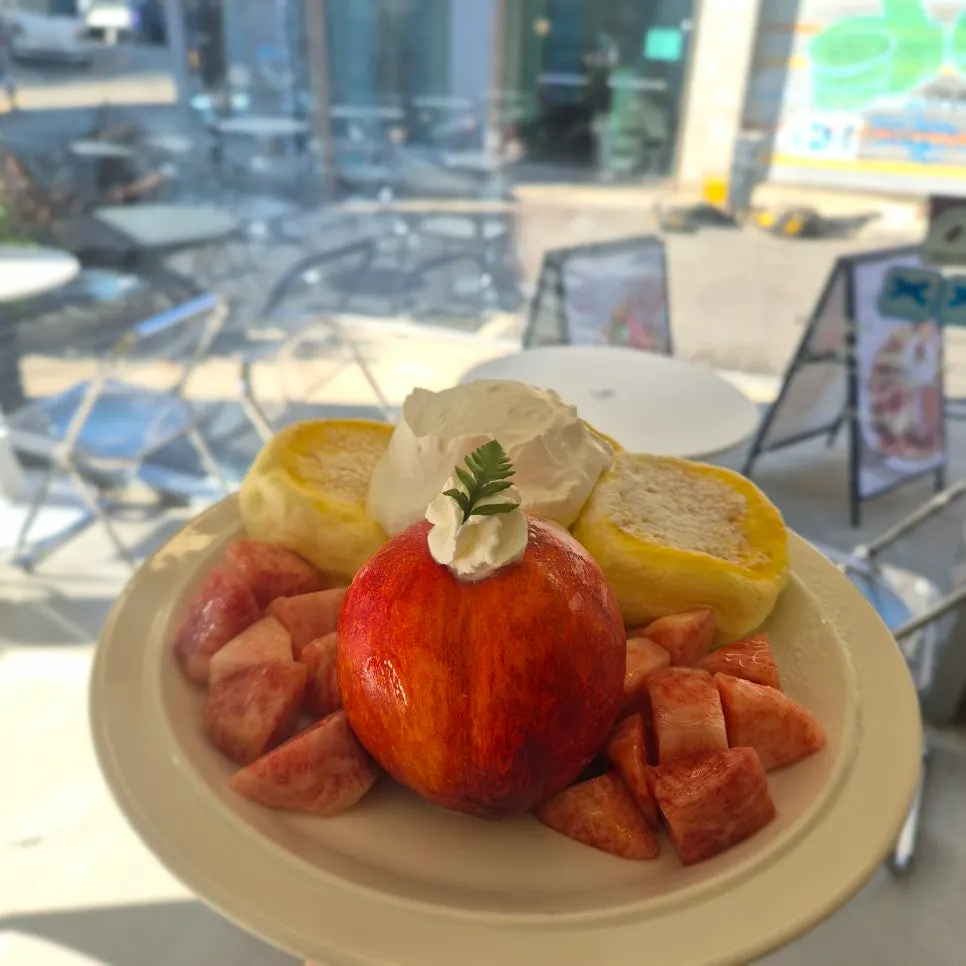 A soufflé cake topped with seasonal fruit