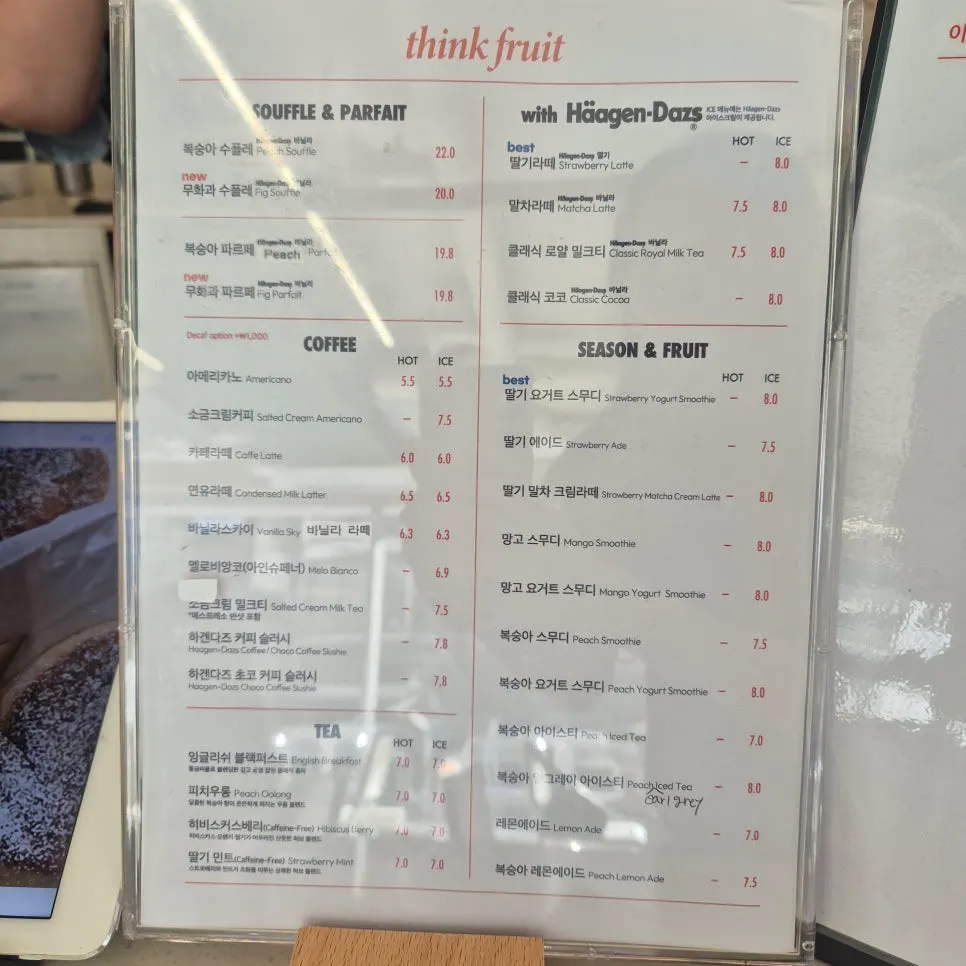 A menu board listing fig and peach soufflés