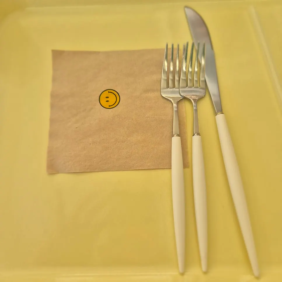 A smiley-face-printed napkin on the table