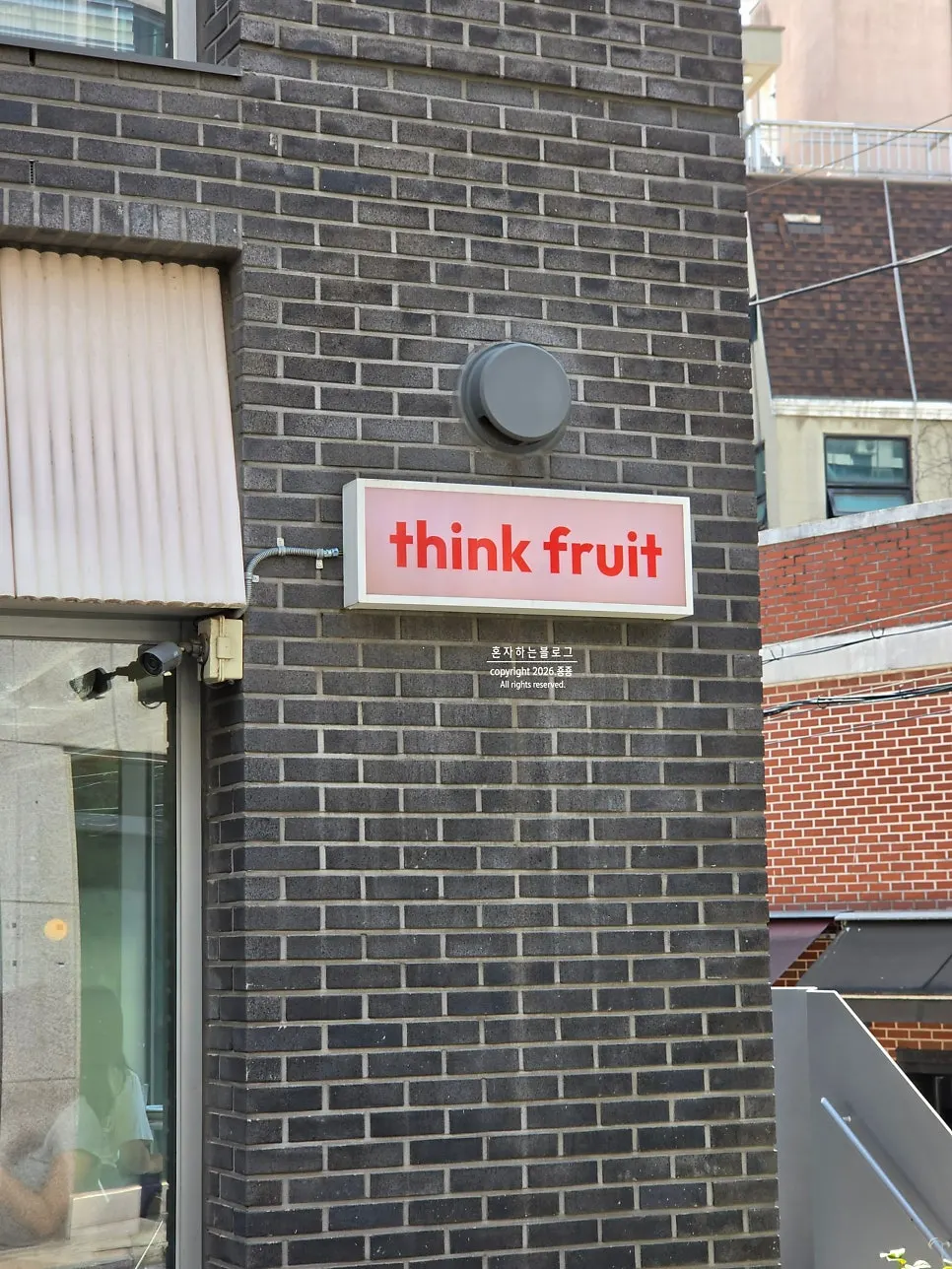 Think Fruit's storefront seen through the glass window