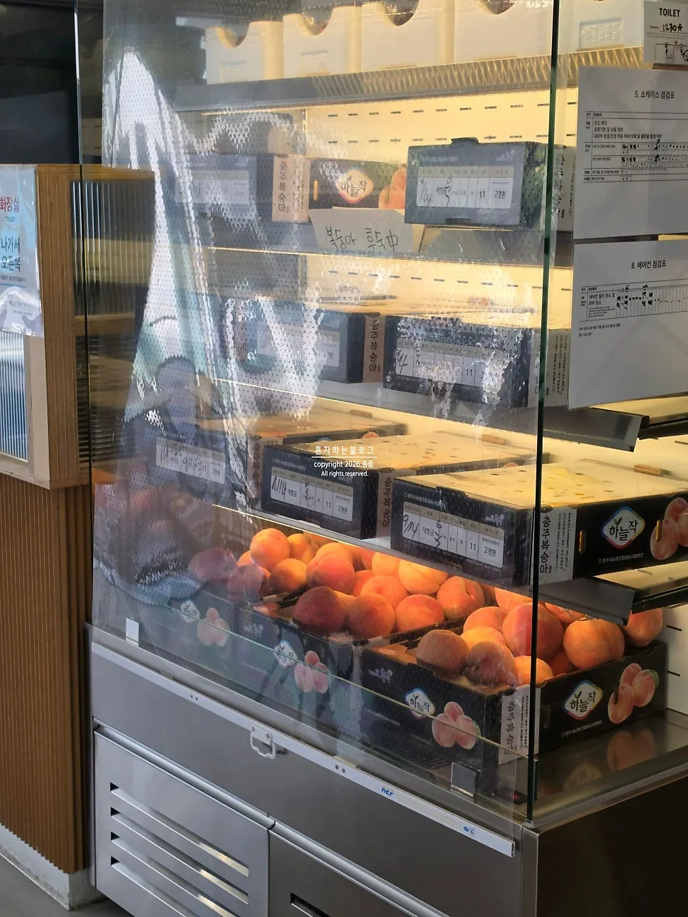 Peaches ripening in Think Fruit's display window