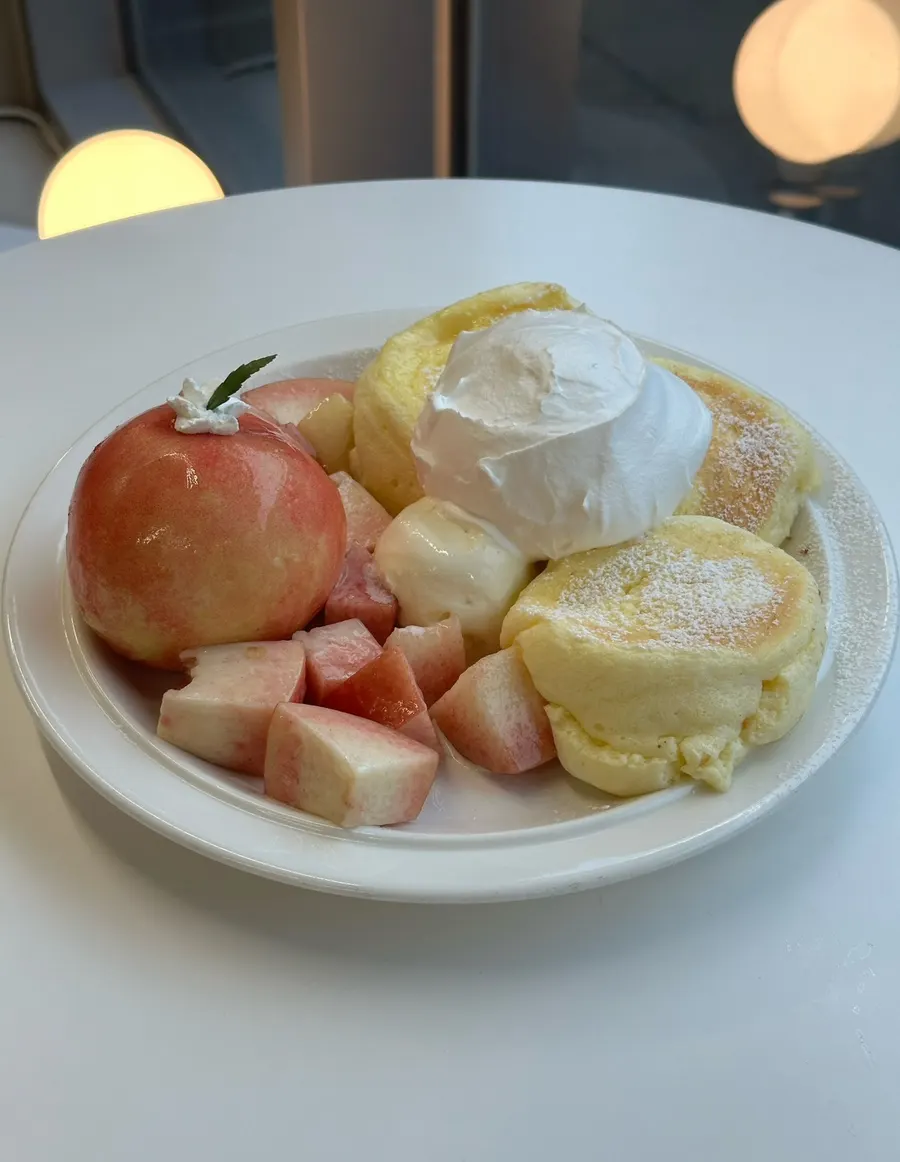 Three soufflé pancakes with peach