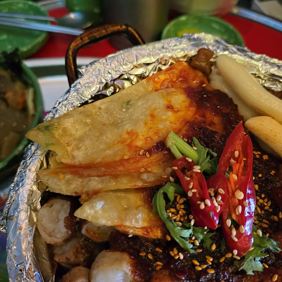 Boneless soup chicken feet topped with daechang and napjak mandu