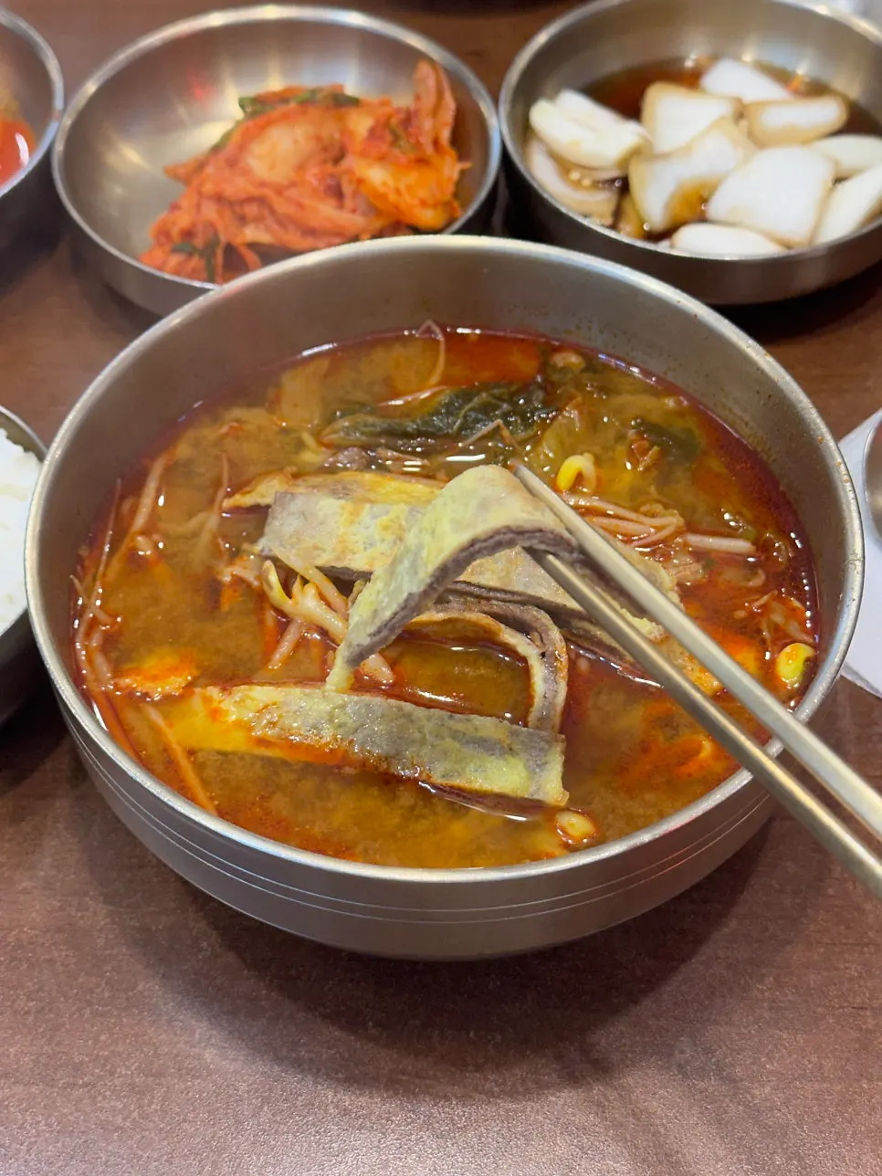 A spoonful of hot yukjeon gukbap broth