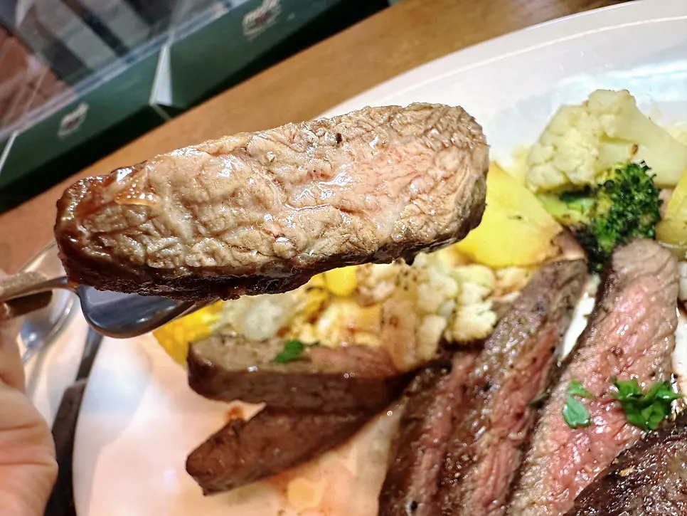 Steak plate served with roasted vegetables and mashed potato