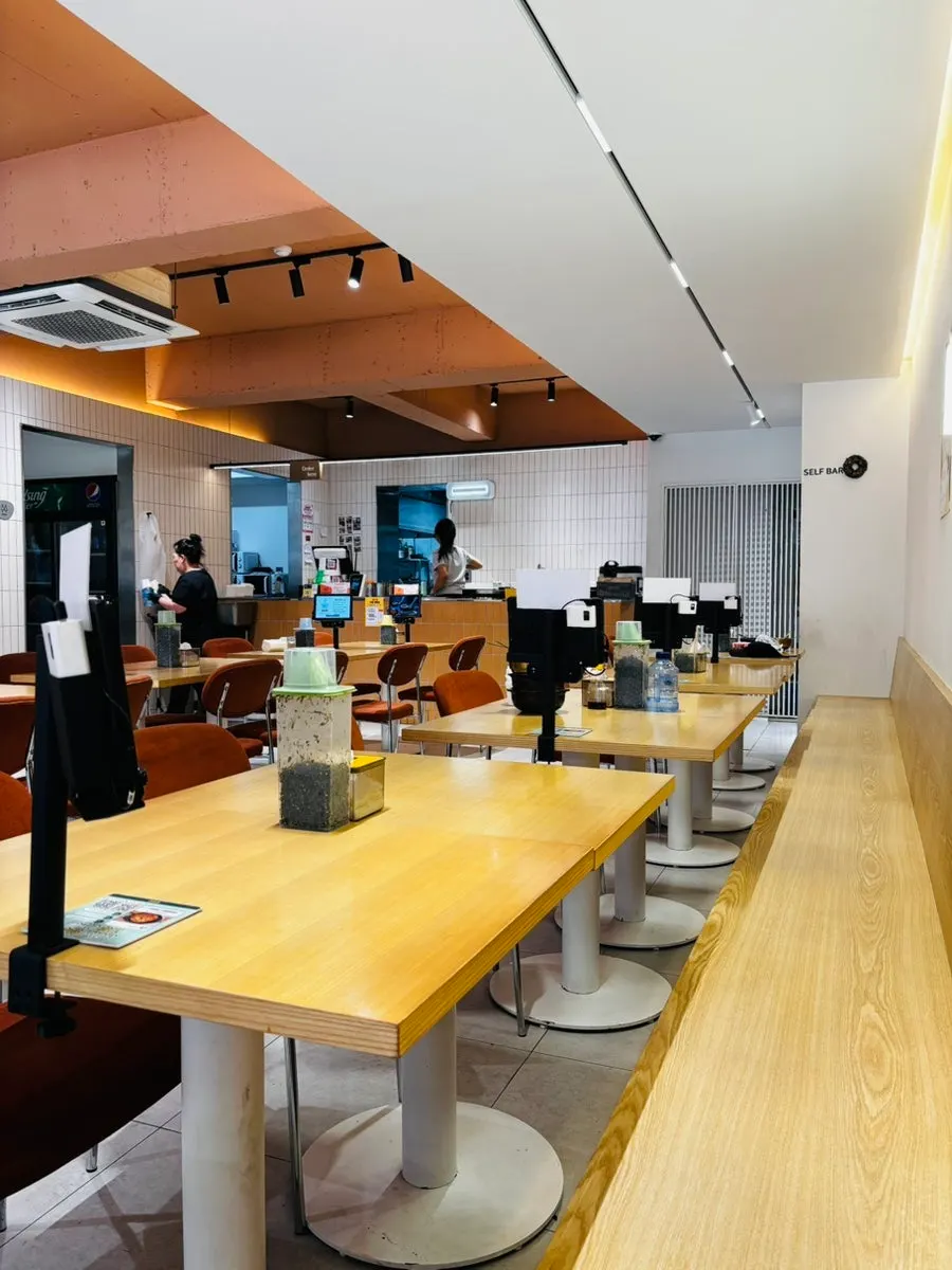 Tables and seats neatly arranged in the spacious restaurant