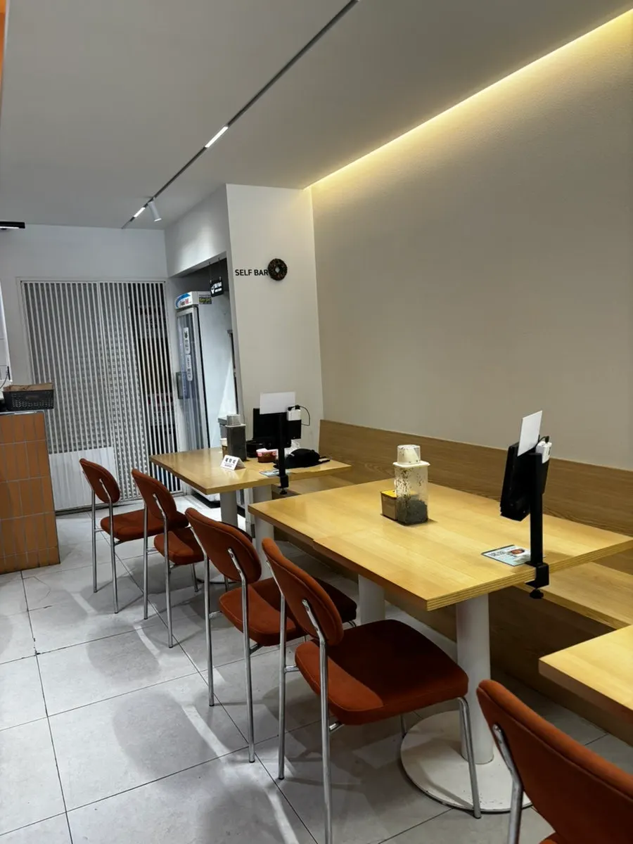 Interior with orange lighting and brown chairs