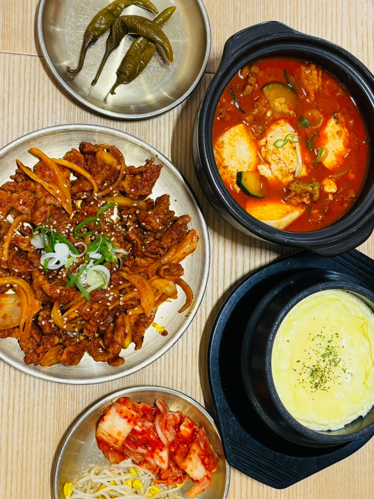 Sundubu-jjigae with brisket and bulgogi stir-fry spread