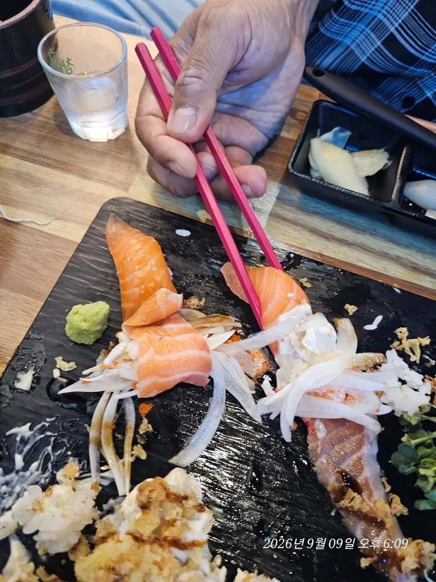 Brushing soy sauce onto long-tail sushi