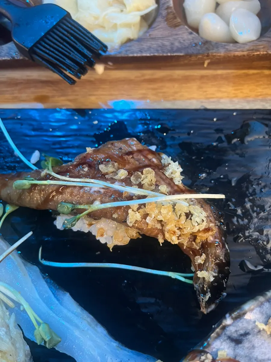 Long-tail sushi with its tail draped down