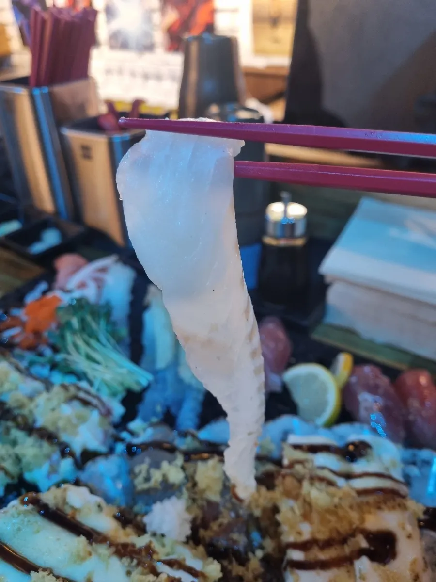 A single piece of halibut long-tail sushi