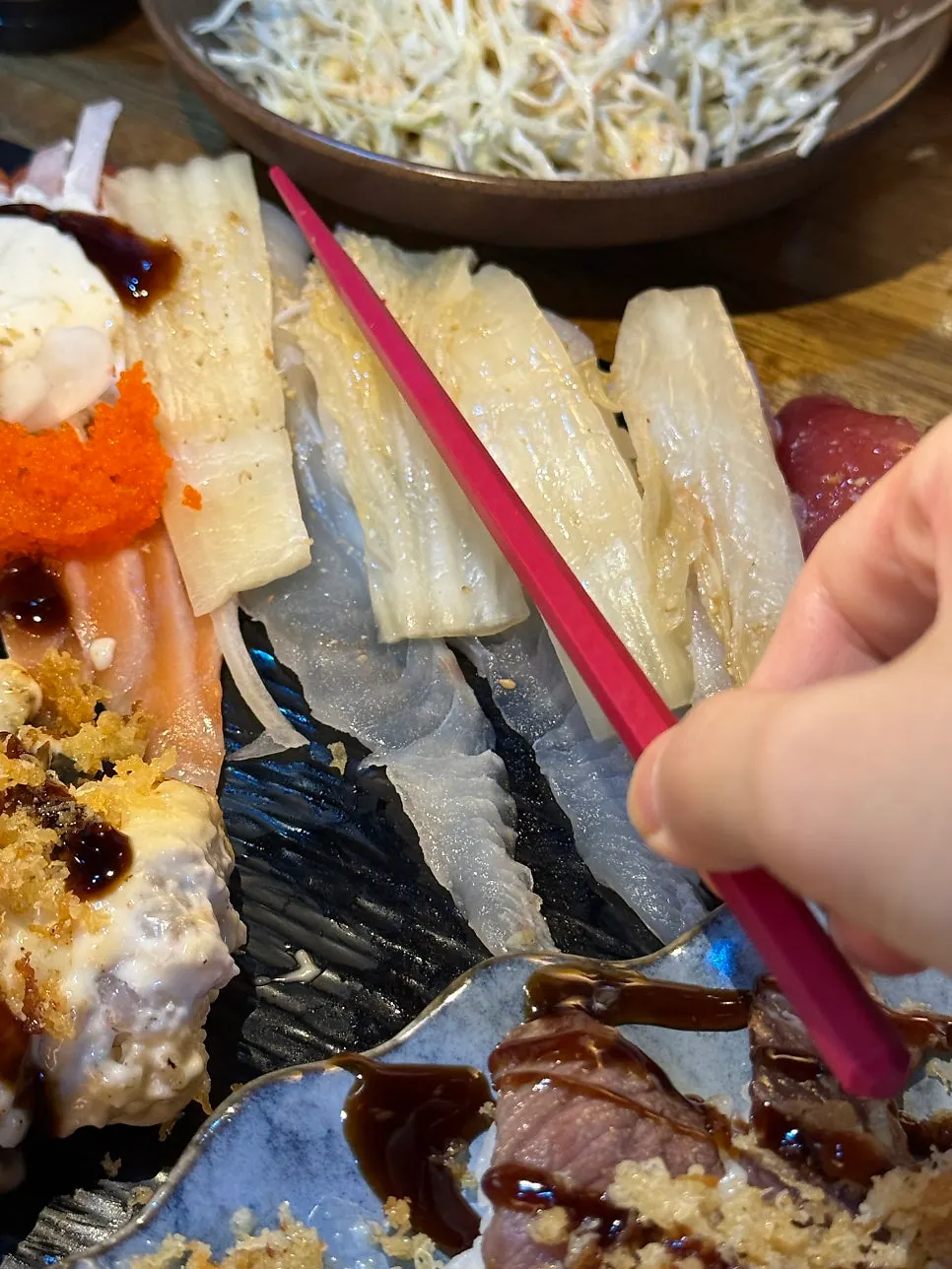 Extra-long tail sushi compared in length to chopsticks