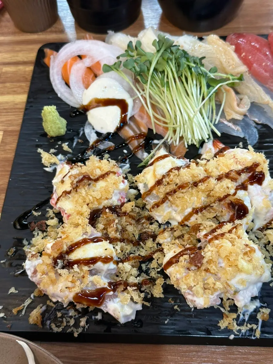 Torched aburi sushi topped with sauce and garnish