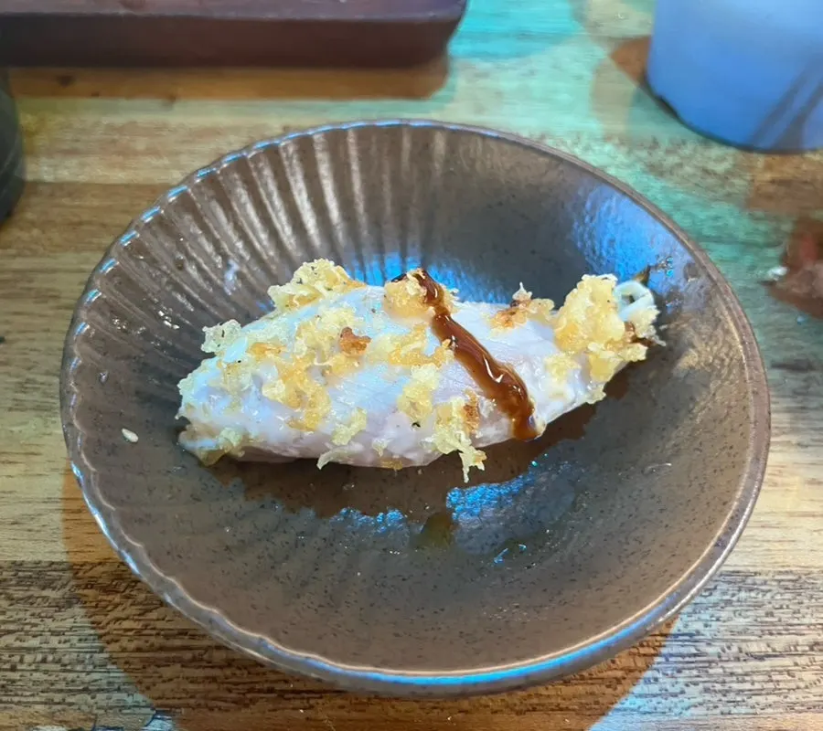 Eating the flounder and baek-kimchi sushi in one bite