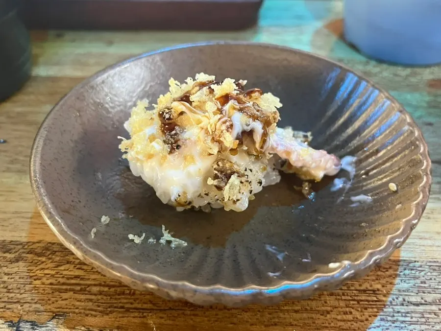 Crab sushi topped with sauce