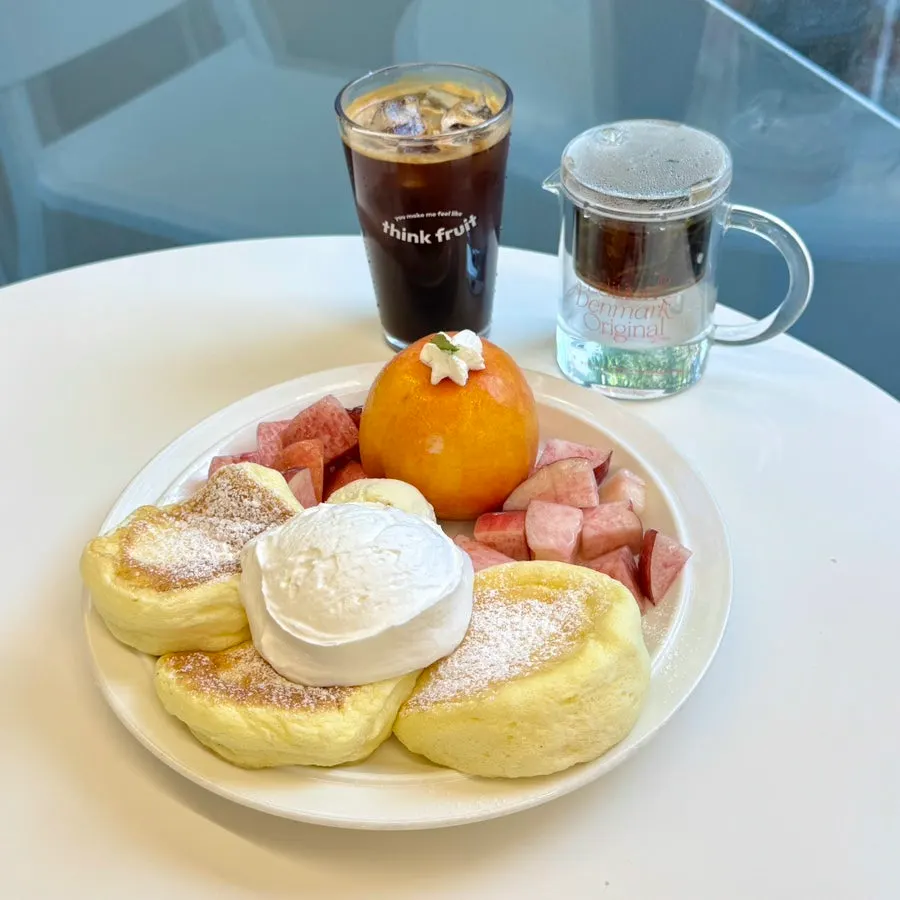 Table setting with peach soufflé, peach oolong tea, and Americano