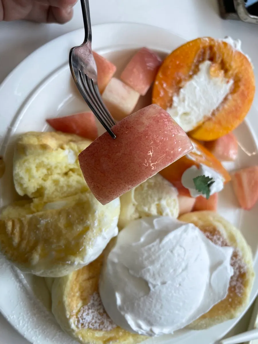 A cross-section of the fluffy soufflé pancake cut with a knife