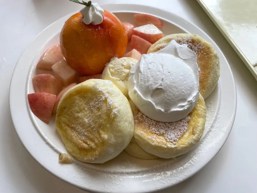 Final shot of the peach soufflé with two drinks