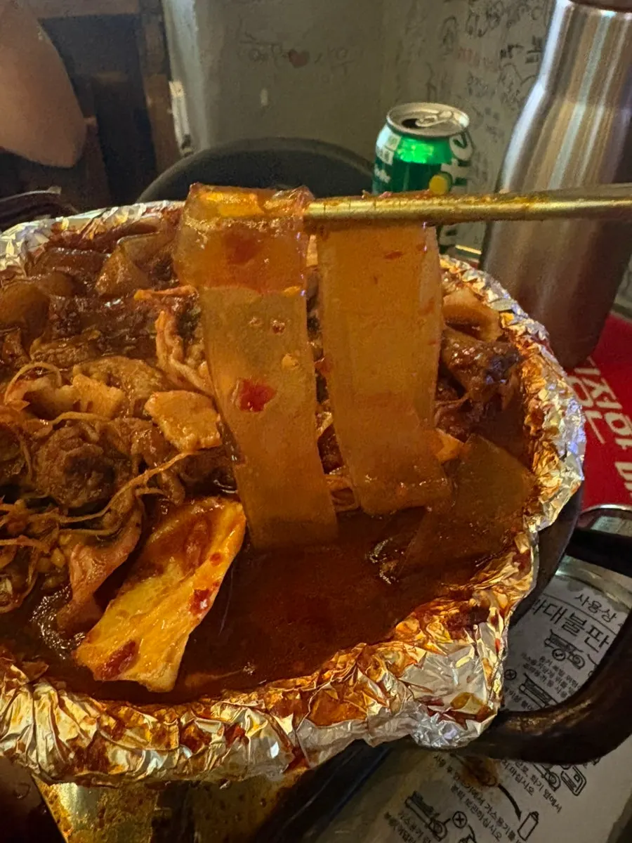 Noodles scooped up from the soup chicken feet