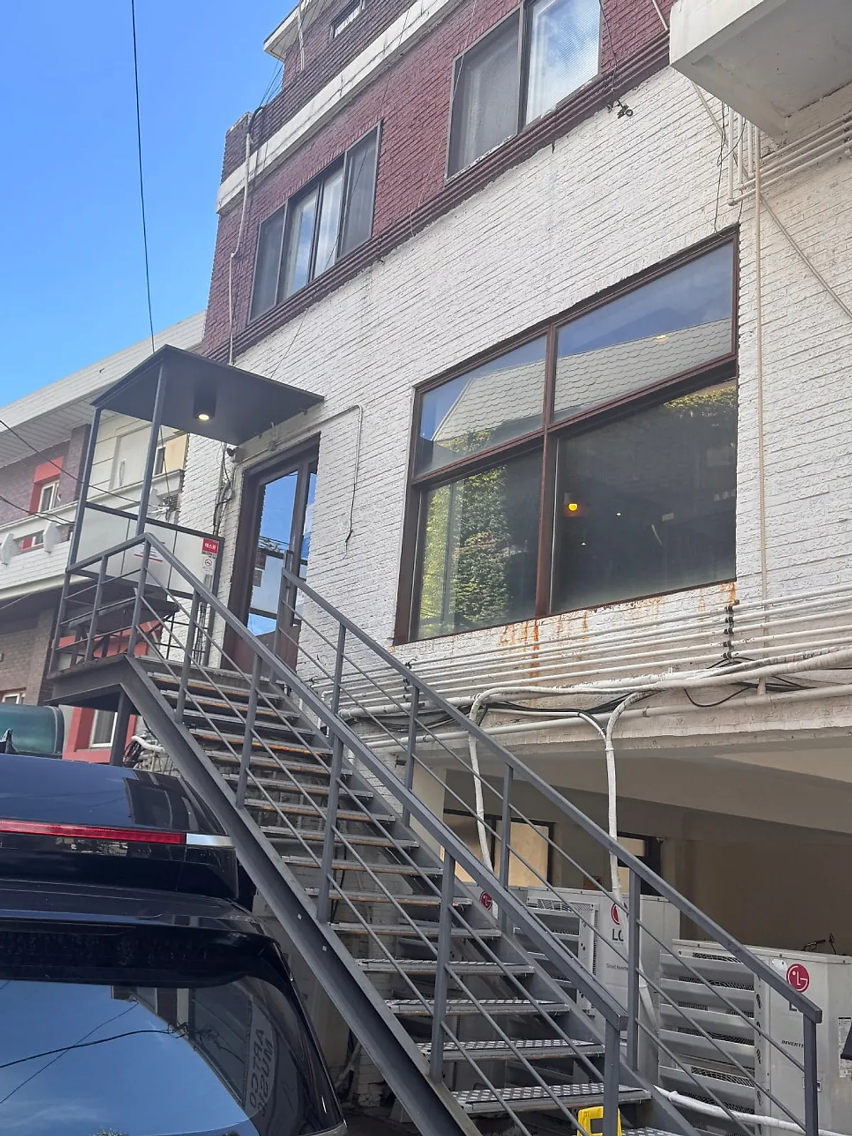 Exterior of UWA Hongdae Main Branch in a white-brick building