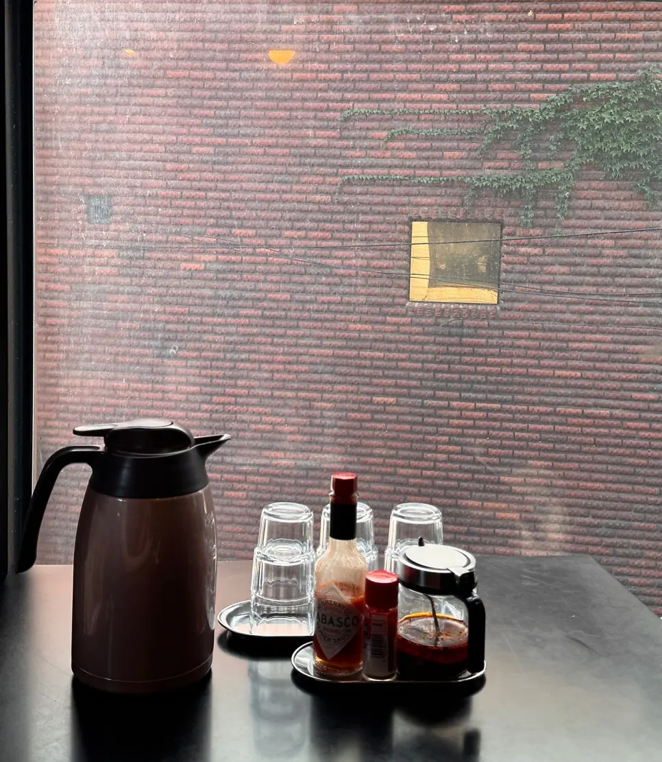 Table with a water bottle, cups, and basic seasonings